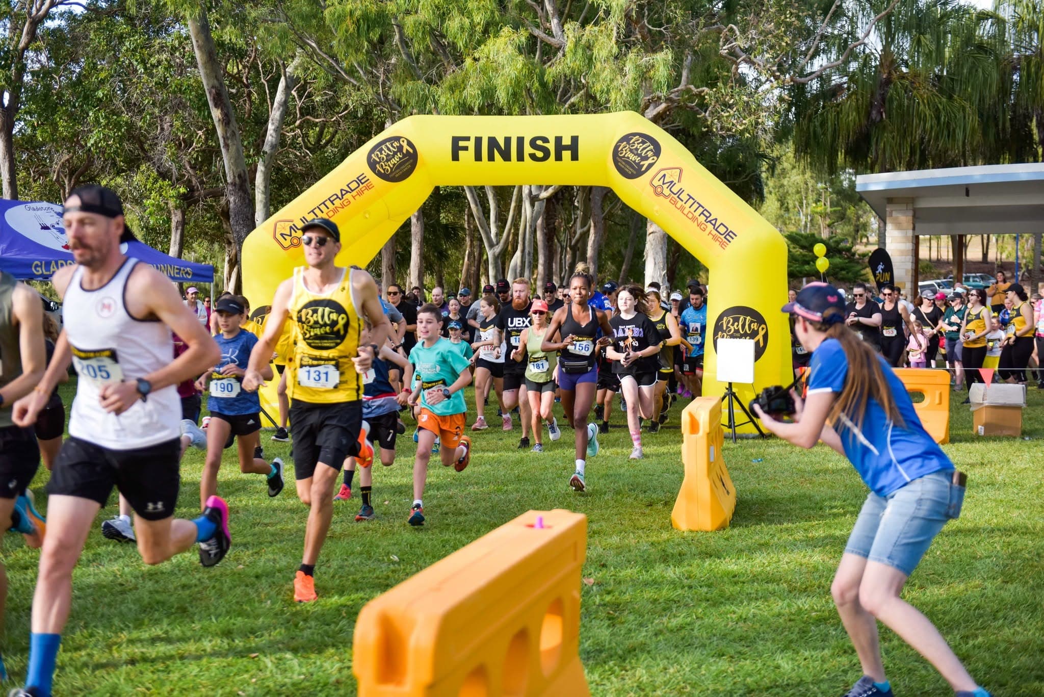 Runners passing through the Multitrade-supported Bella the Brave fun-run arch