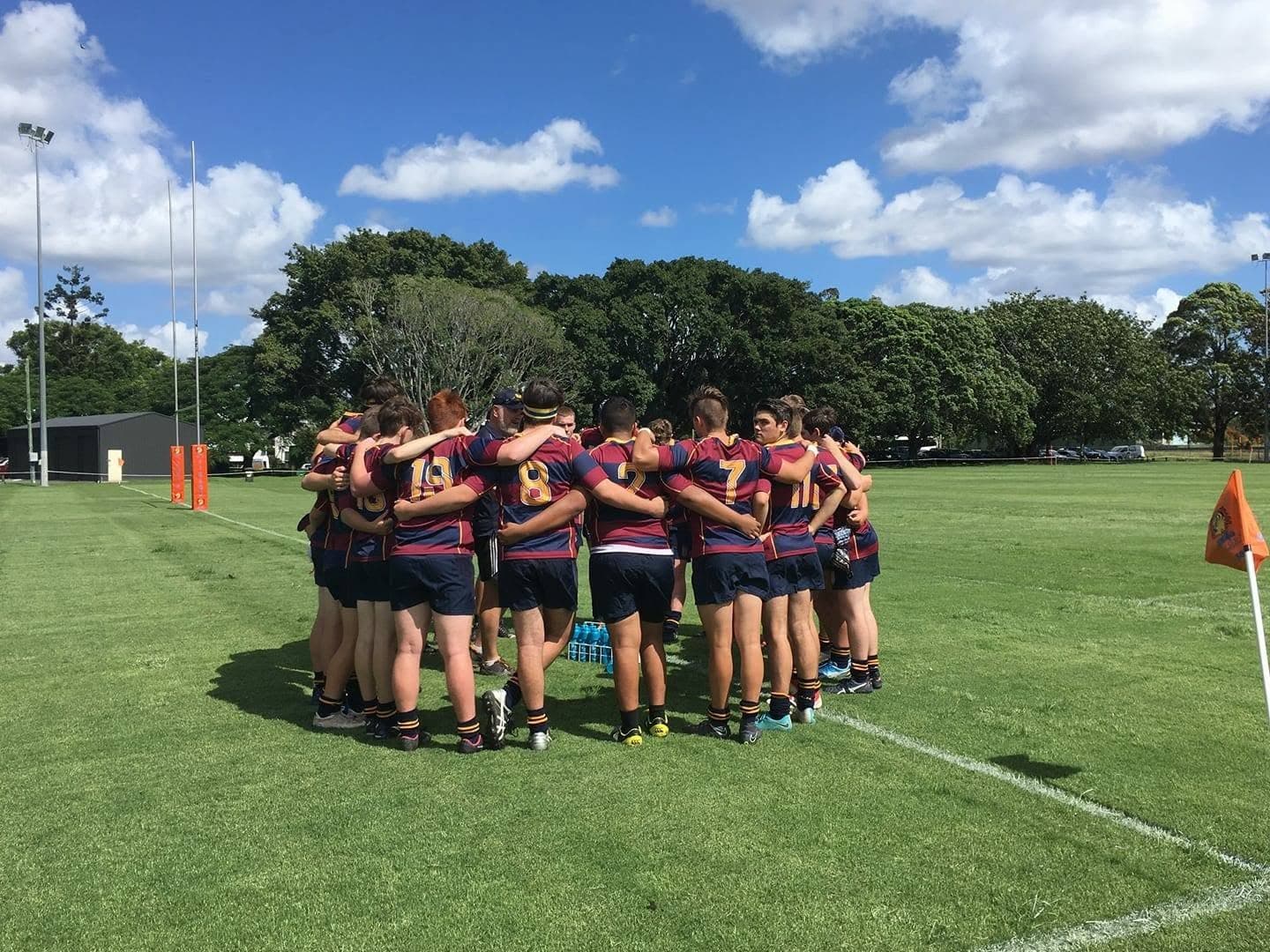 Gladstone rugby union team in a huddle on the field