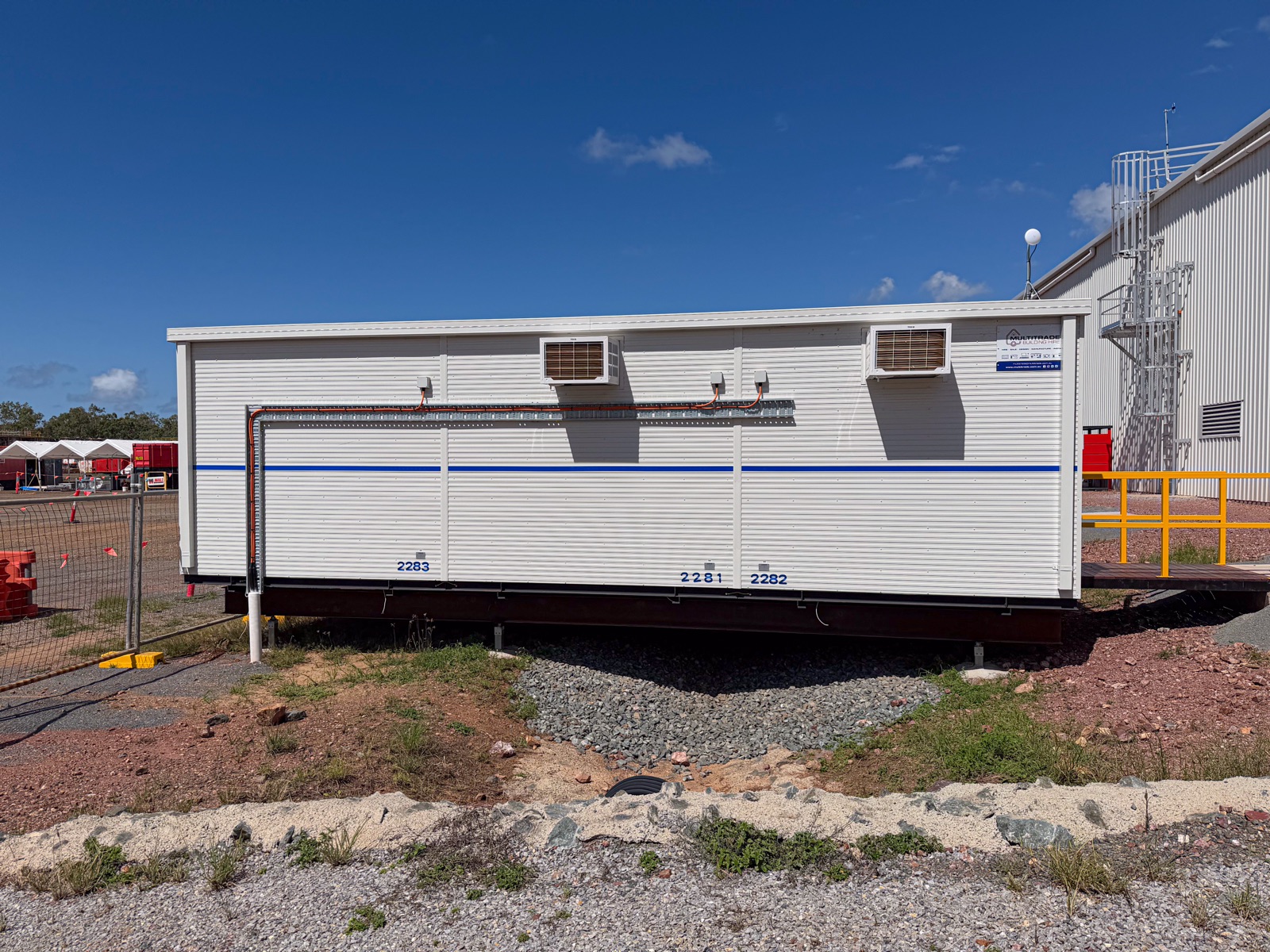 Office complex exterior — angle view with entry ramps