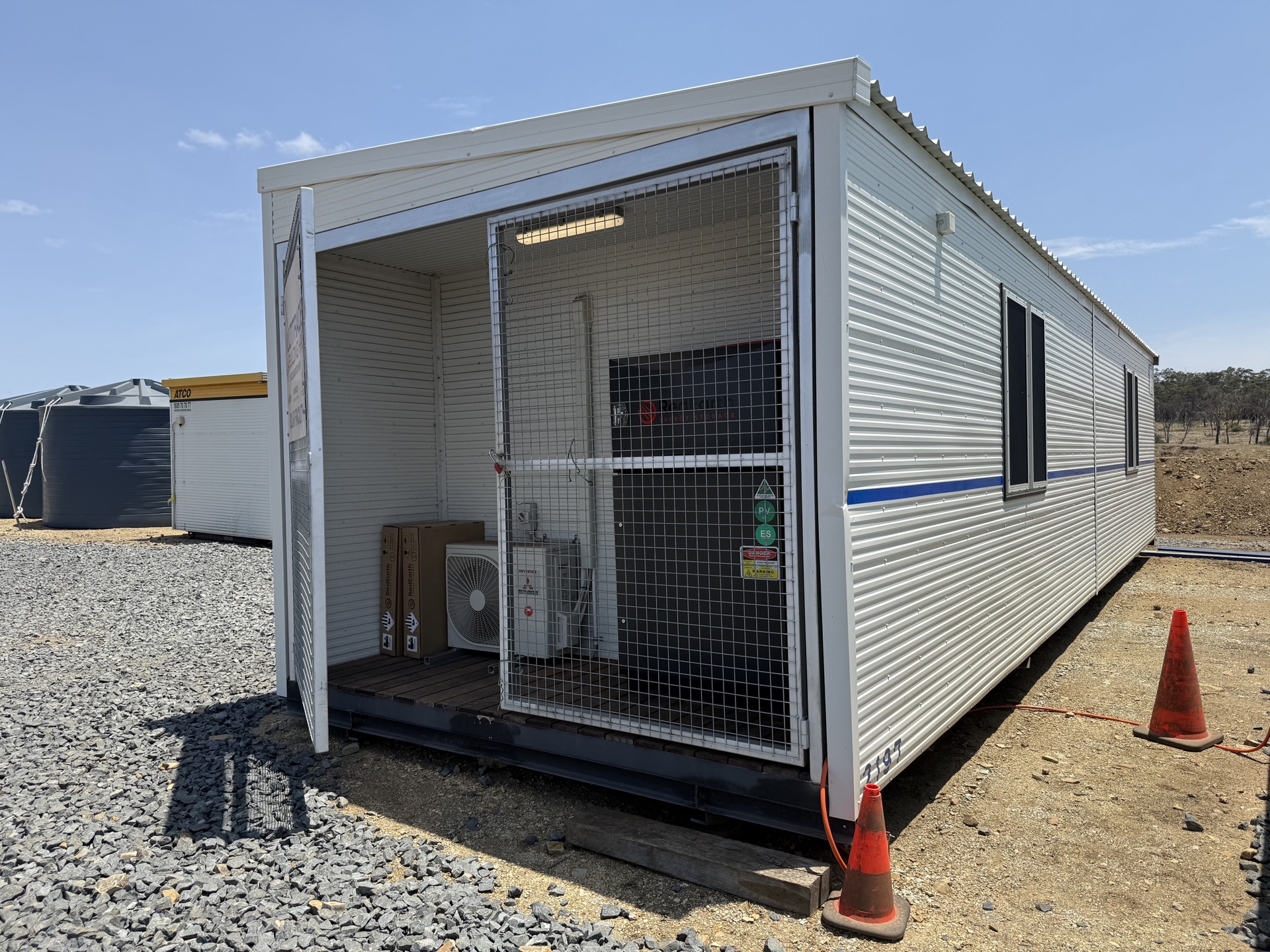 End view showing mesh security gate and air conditioning unit