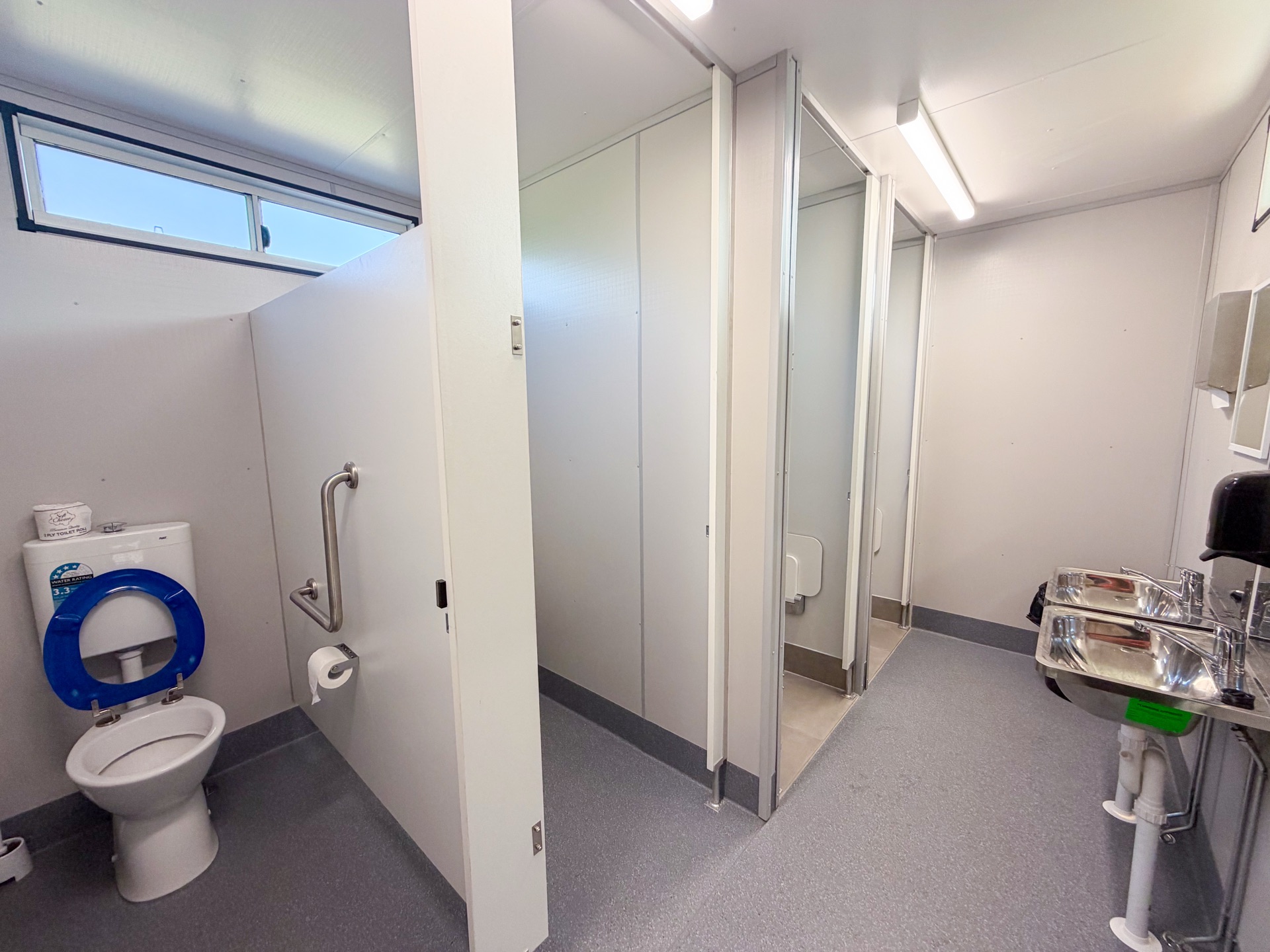 Interior — ambulant cubicles with grab rails and S/S basins