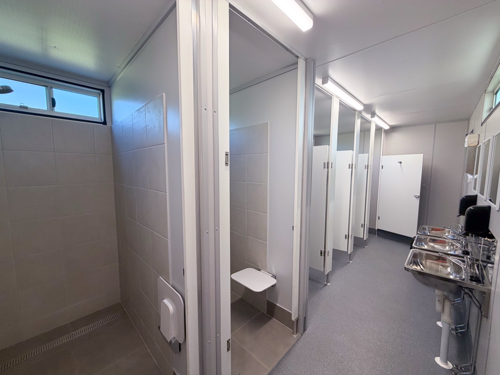 Interior — tiled shower cubicles with bench seats